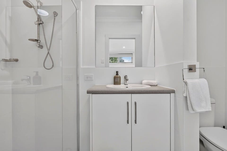 Fresh white ensuite with shower & vanity