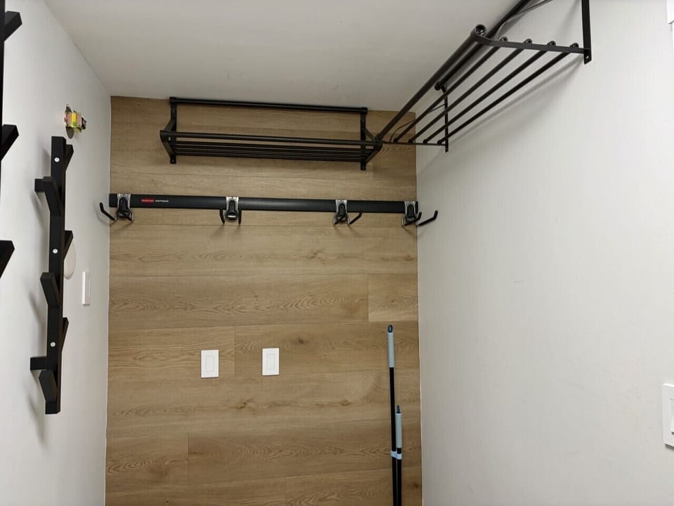 Front foyer/entrance area with a bench, ski rack.