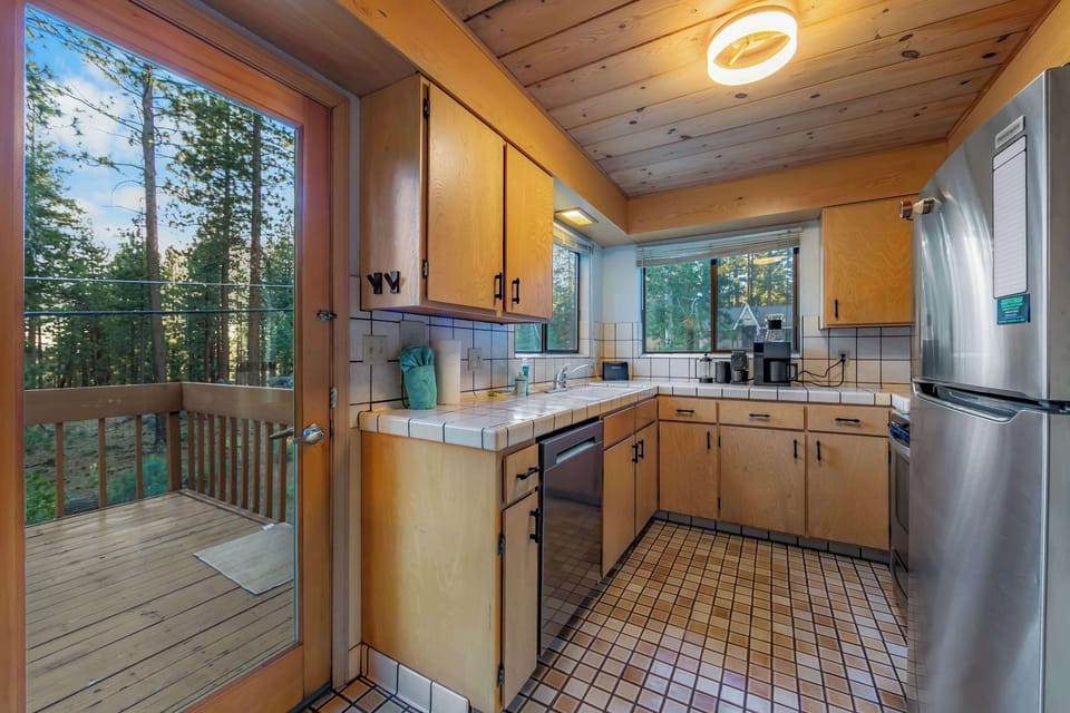 Prepare meals with ease in the fully equipped kitchen, offering ample counter space and everything needed for your Tahoe getaway