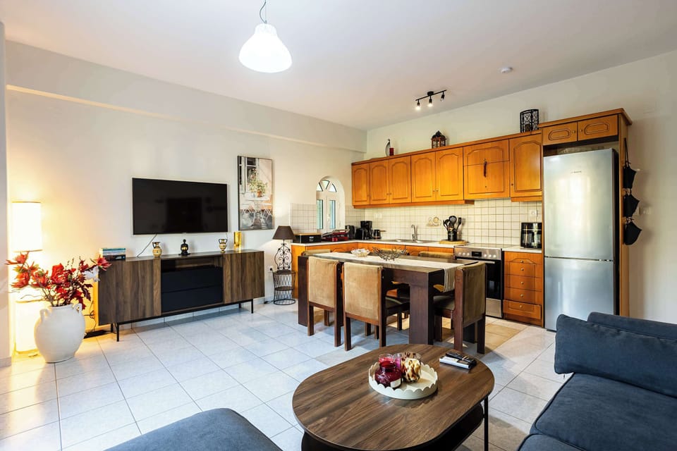 Spacious living room with Smart TV, comfortable seating, and an open layout.