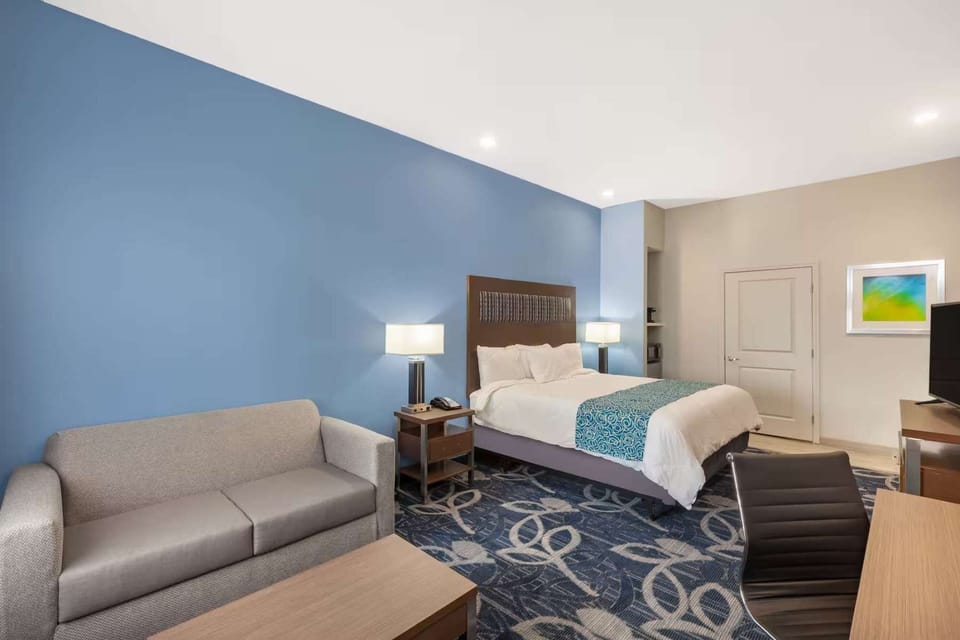 King bed with sofa, desk, and warm lighting