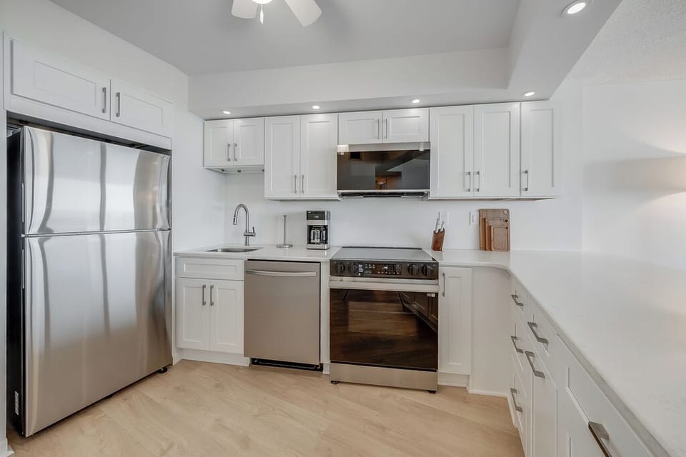Complete with a full suite of stainless steel appliances, including a dishwasher for quick cleanup.