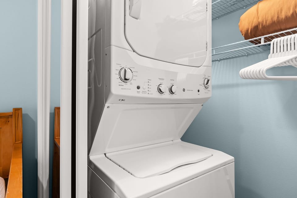 Stacked washer and dryer in a compact laundry closet