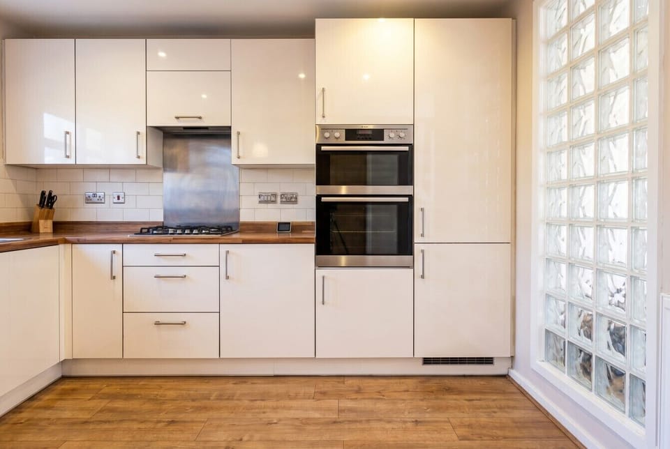 Sleek kitchen with double oven and gas hob for easy family meals