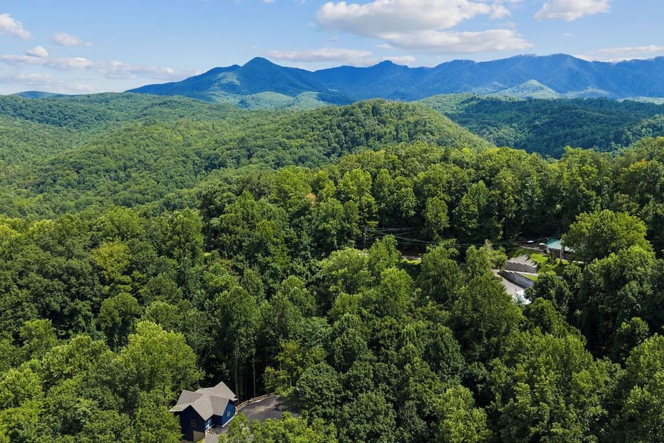 Surrounded by the beauty of the Smokies, the cabins offer a peaceful wooded setting with the Great Smoky Mountains rising in the distance.