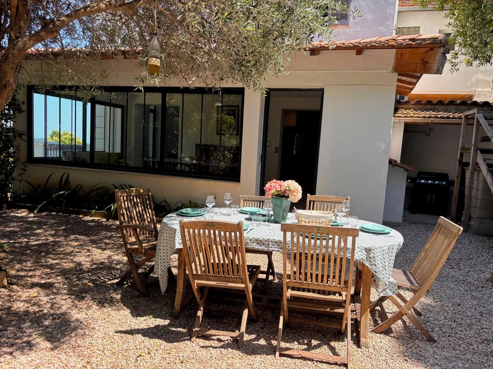 Outdoor dining under the olive tree