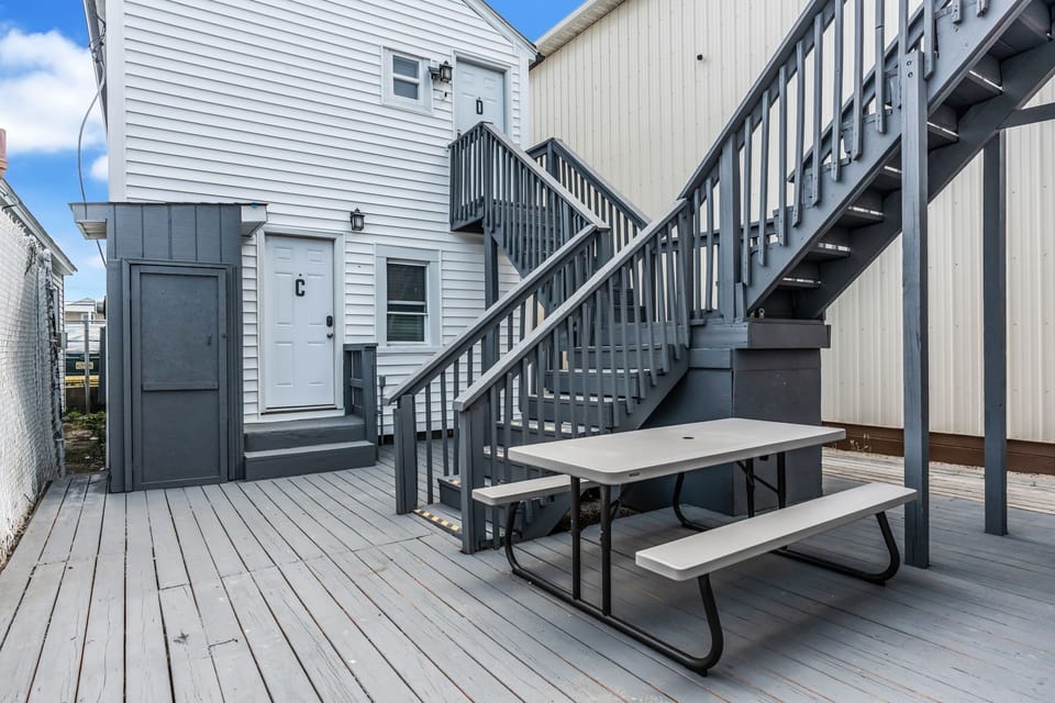 Spacious gray deck with private entry and outdoor picnic seating