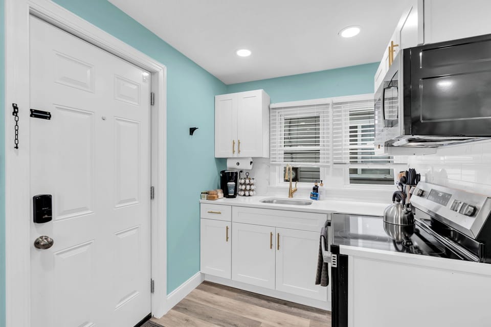 Bright modern kitchen with stainless appliances and cheerful coastal style