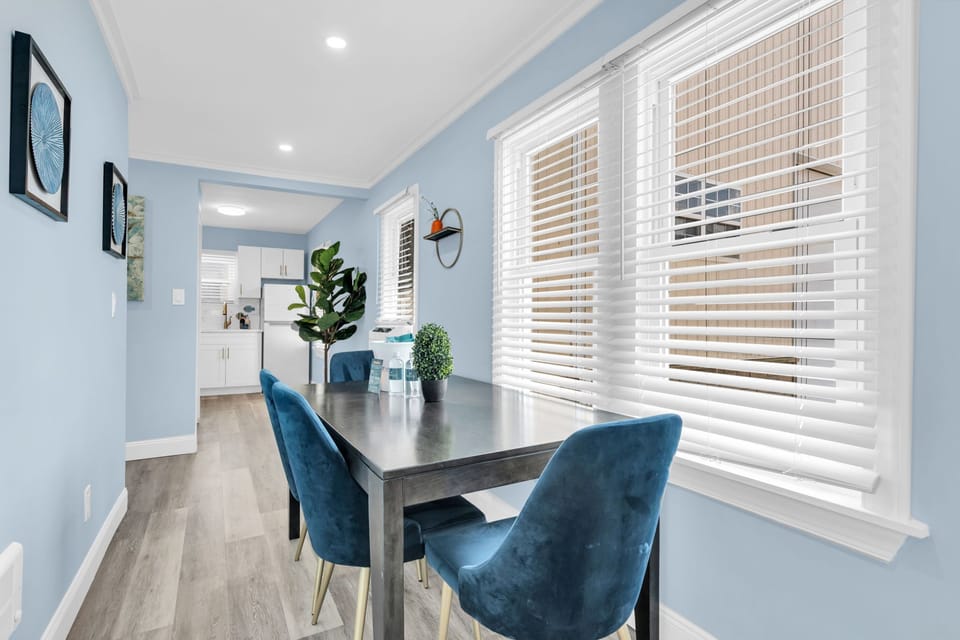 Bright, stylish dining nook with large windows and modern seating