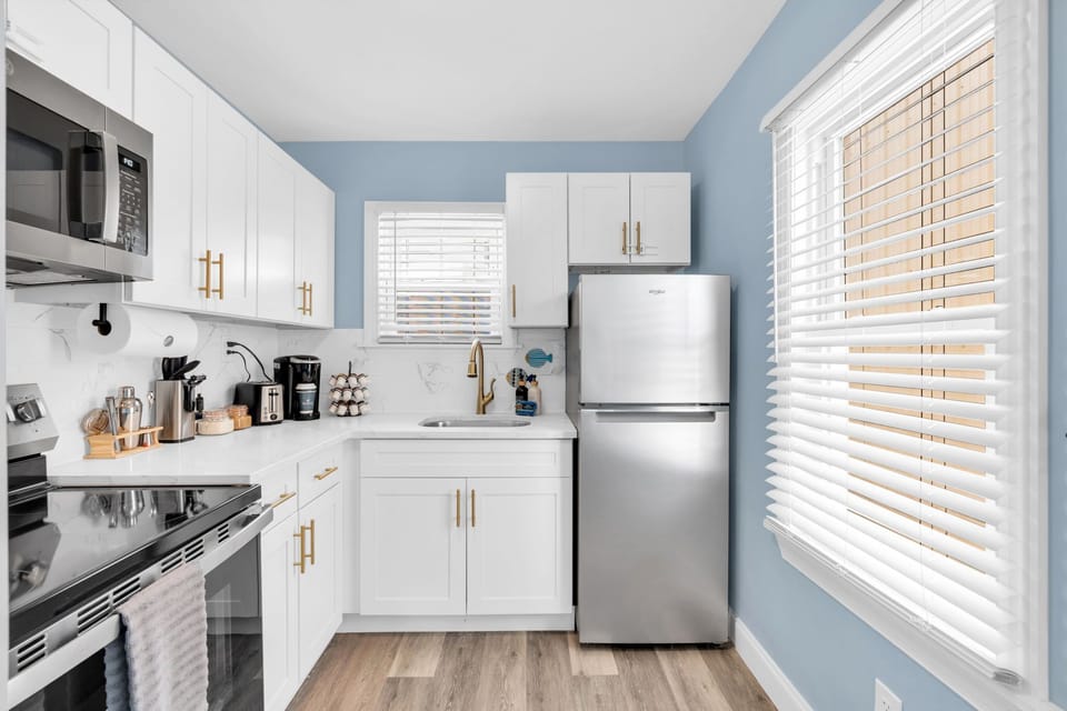 Bright modern kitchen with stainless appliances and sunny windows