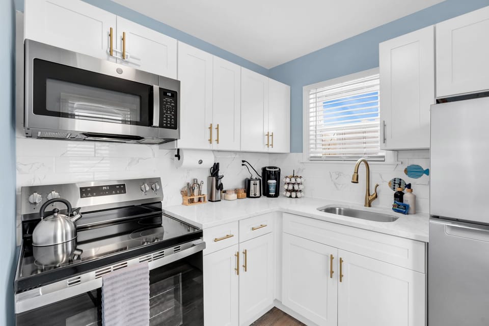 Bright modern kitchen with stainless appliances and sunny coffee nook