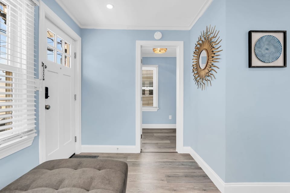 Bright, stylish entryway with natural light and coastal charm