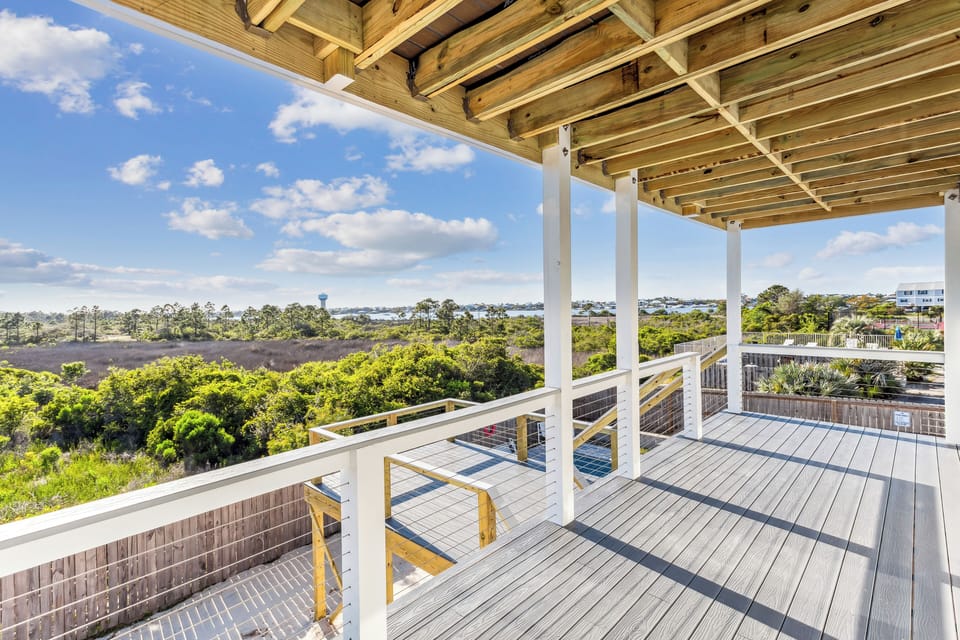 Unwind on the main-floor covered porch, a comfortable spot for morning coffee.