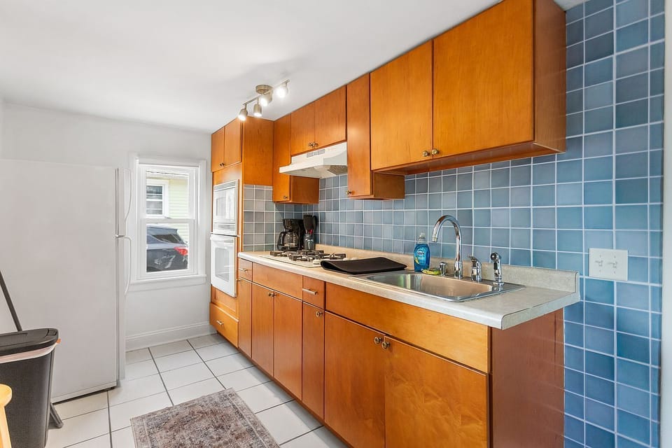 The South Apartment galley kitchen has all appliances and utensils provided.