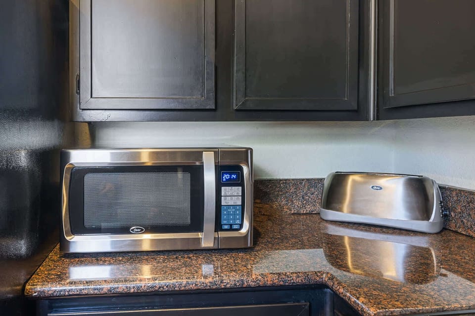 Modern kitchen essentials with sleek stainless steel appliances and elegant granite countertops.