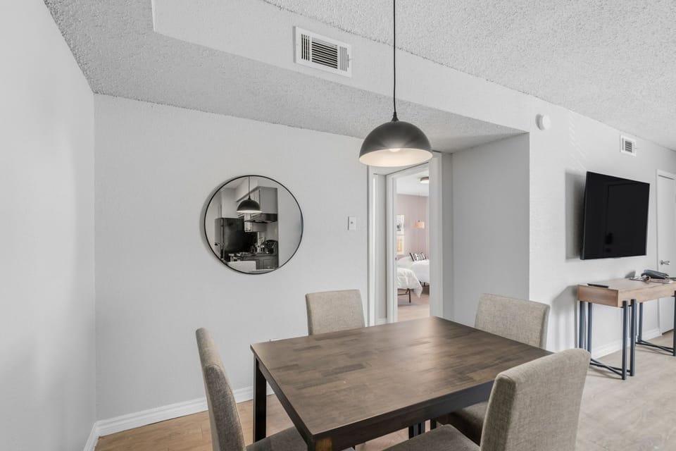 Chic dining area with modern furnishings and a cozy ambiance, perfect for family meals or entertaining guests.