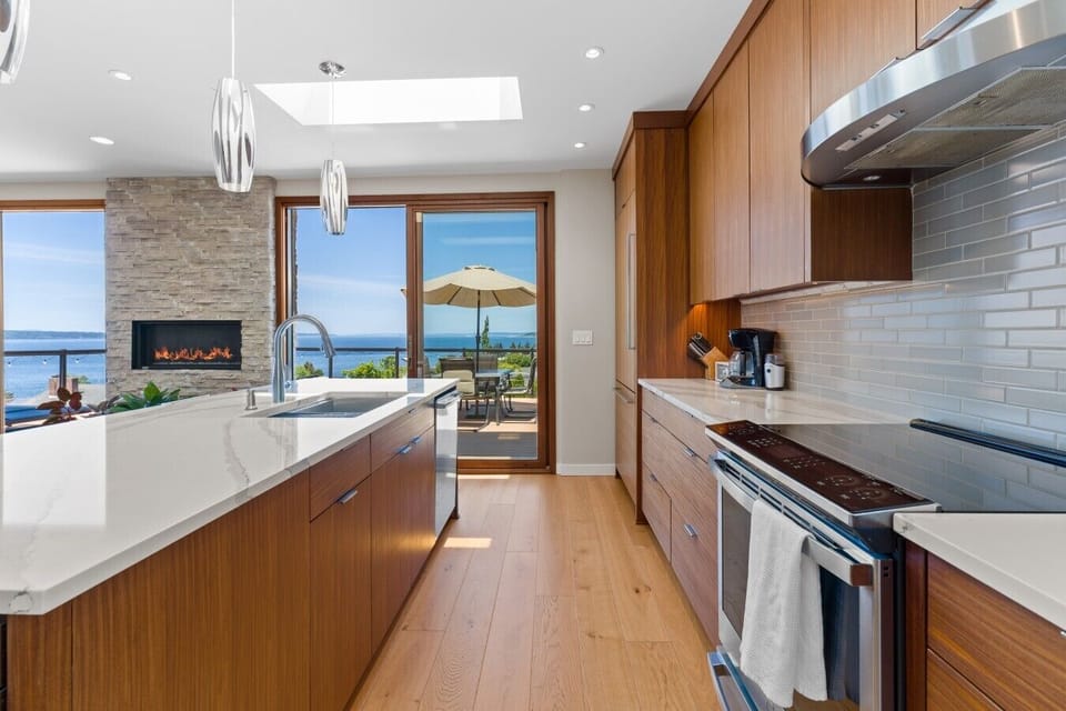 Chef`s kitchen flows to a fireside lounge framed by sweeping sea views.