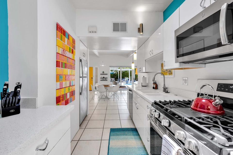 Well-equipped galley kitchen with gas cooking and backyard access