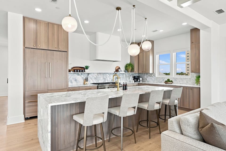 Beautifully designed with a spacious marble island and bar seating, this kitchen is made for gathering over great meals.