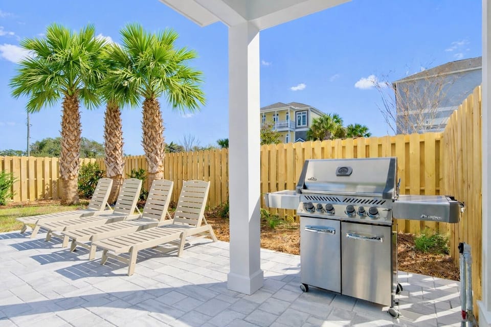 Escape to your private backyard oasis featuring a heated pool, plenty of lounge chairs for soaking up the sun, corn hole, and a covered porch with lounge seating. Dine alfresco at the outdoor dining table or grill out with the gas grill.