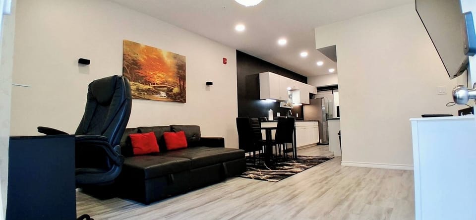 Living Room: Spacious with sofa bed, desk, 65” TV, blackout curtains.