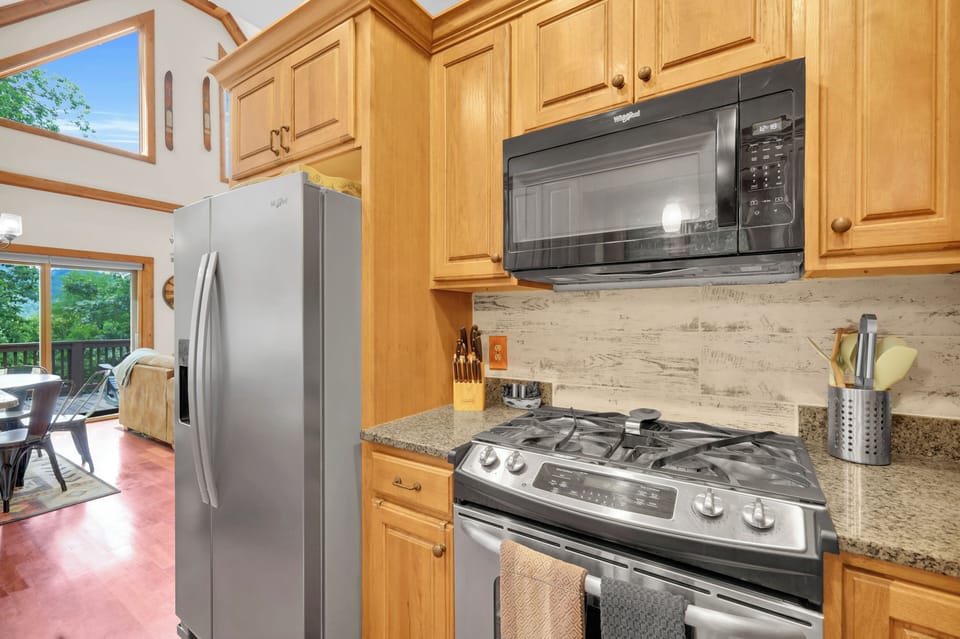 Cook up mountain meals in this bright open kitchen, where stainless appliances, deck access, and natural light make every meal feel like an occasion.