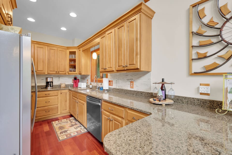 Cook up mountain meals in this spacious granite kitchen, where warm wood cabinets and stainless appliances combine style and function for effortless meal prep.