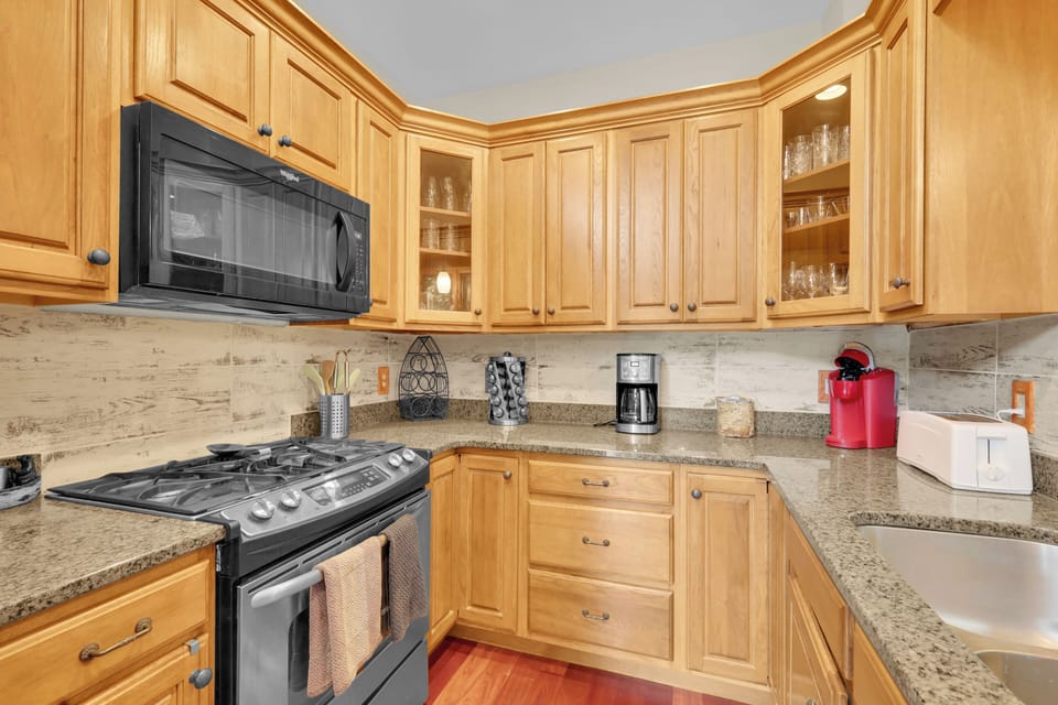 Cook up mountain meals in this warm, fully equipped kitchen, featuring granite counters and ample cabinet space to keep everything organized and within reach.