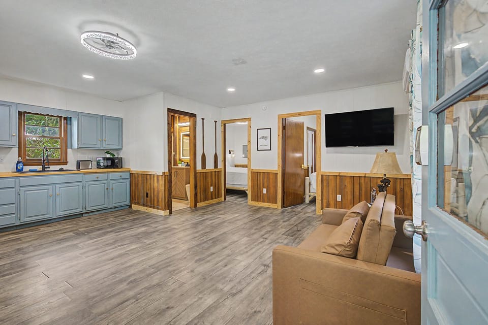 Living Room: Bright space with wooden accents and a sleek TV for entertainment fun!