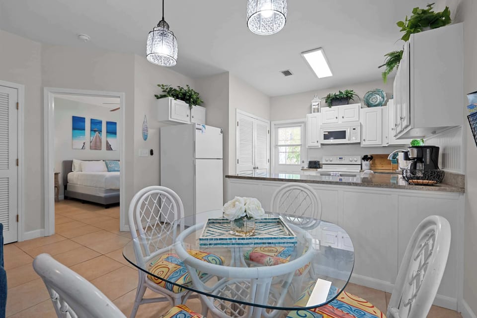 Bright dining area with seating for four and a convenient coffee station nearby.