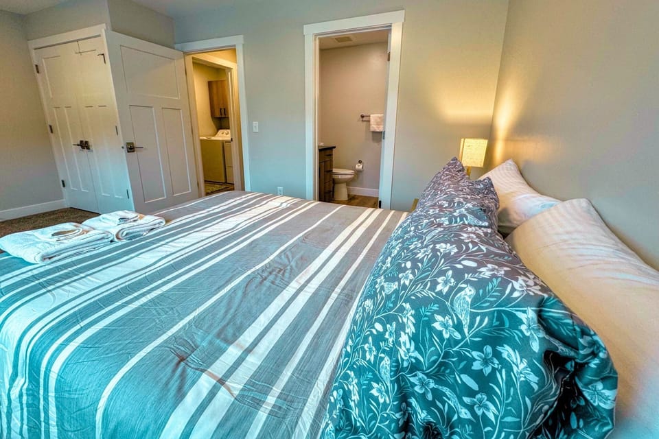 The second bedroom has an en suite bath and the laundry room is just steps away.