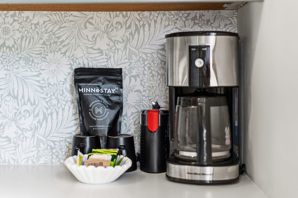 Start your mornings right with premium coffee waiting for you. A stylish coffee maker and fresh beans make brewing your perfect cup easy and convenient.
