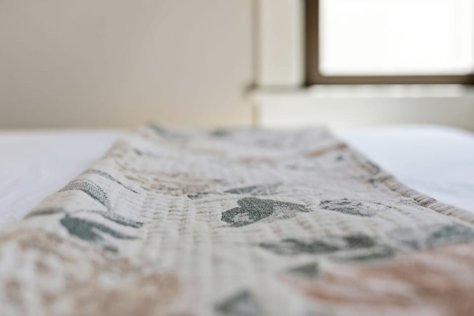 Soft linens with delicate patterns wait to wrap you in comfort after a long day of exploring—your home away from home begins here.