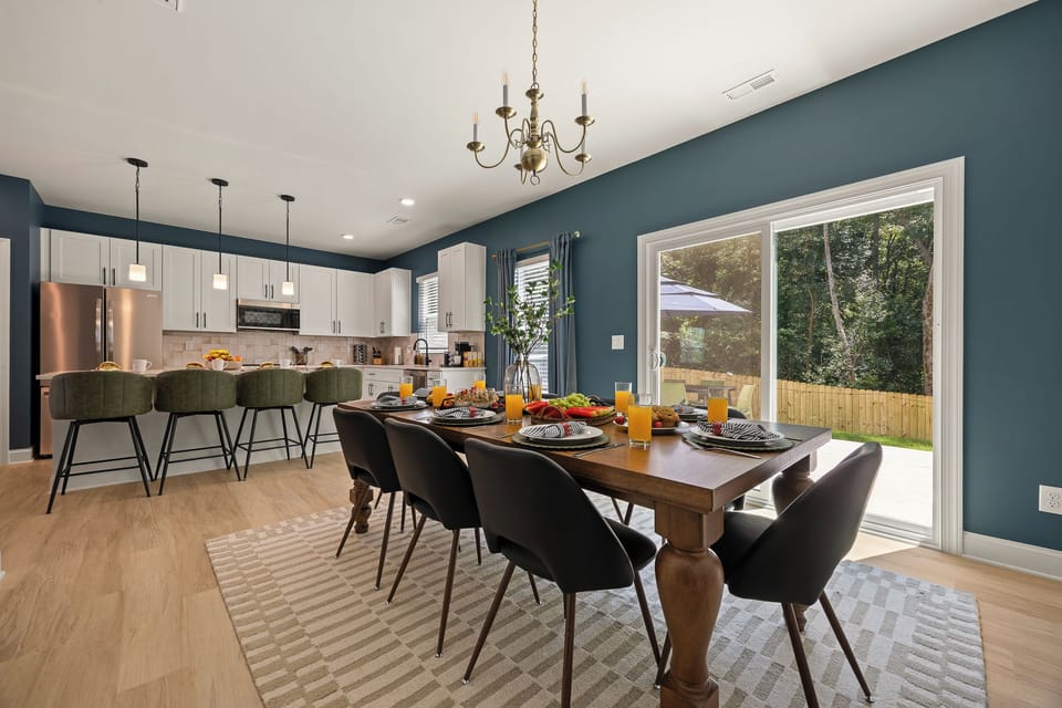 Stylish open dining & kitchen space with backyard views and seating for 10