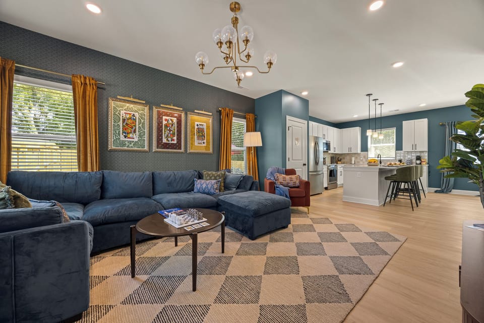 Spacious open living room with designer style and a modern chef’s kitchen