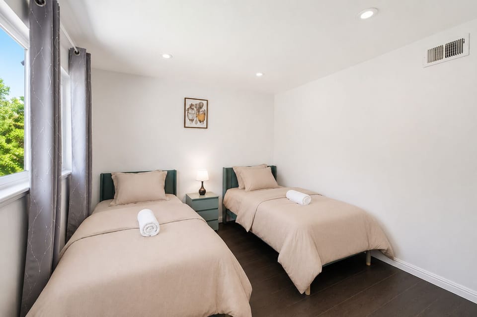 Bright twin bedroom with natural light and a clean, cozy design