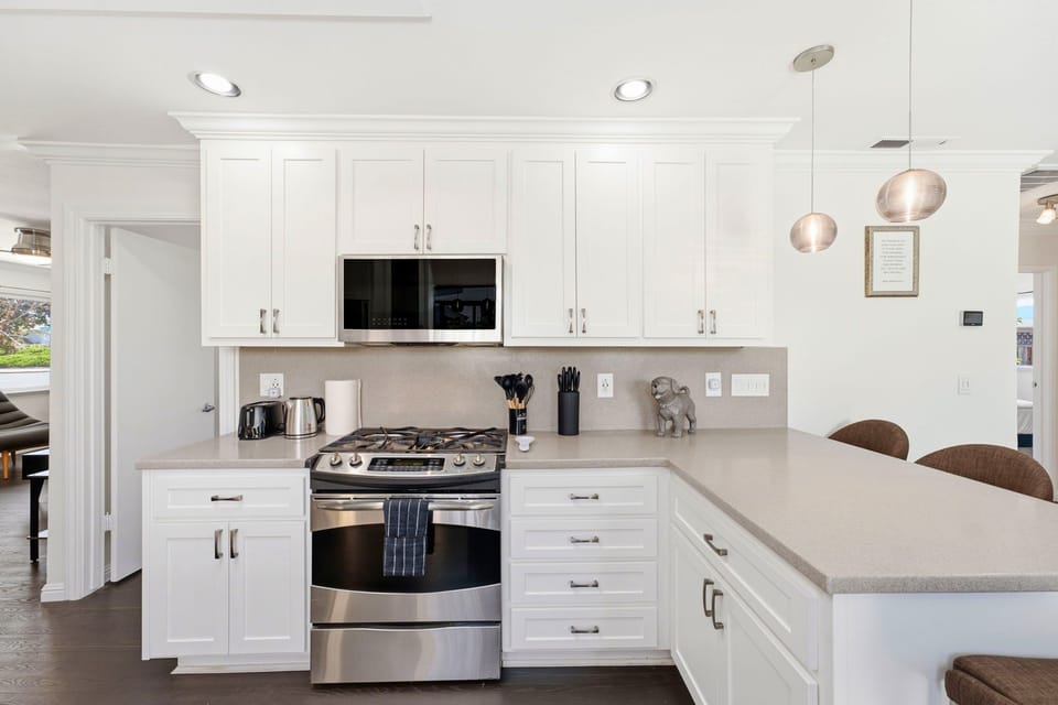 Bright modern kitchen with white cabinetry and spacious breakfast bar