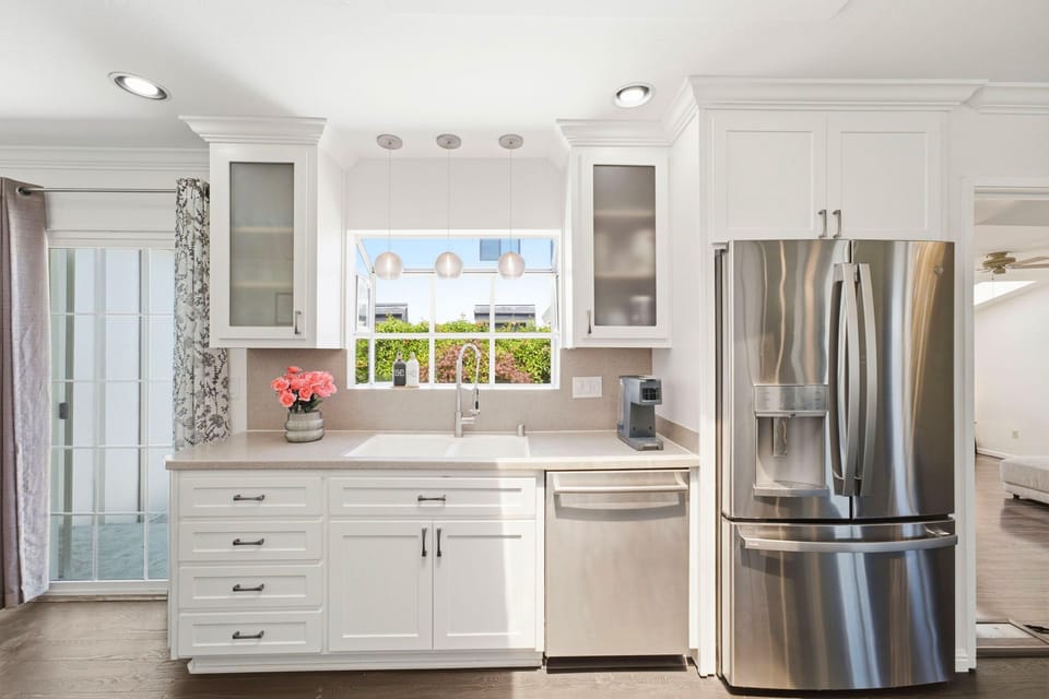 Bright modern kitchen with stainless appliances and sunny farmhouse sink