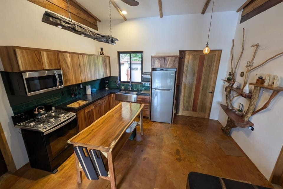 Fully equipped kitchen featuring natural Belizean wood.