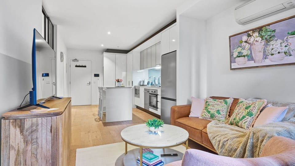 The open-plan living space seamlessly connects the lounge, kitchen, and dining areas.