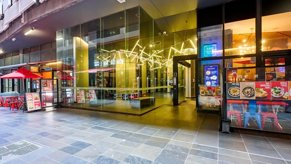The building's vibrant entrance places you in the heart of the action.