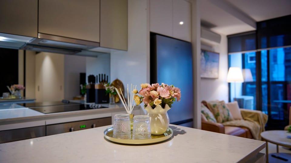 Fresh flowers and stylish finishes complete the sophisticated kitchen space.