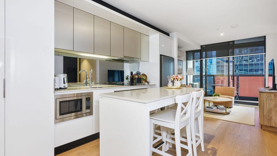Prepare meals with ease in the sleek kitchen featuring a spacious island bench.