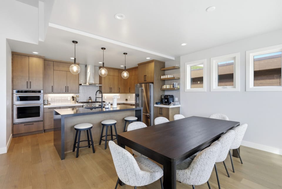 Share meals around the spacious dining table while taking in sweeping lake and mountain views. (Serenity Now)