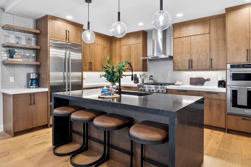 Fully equipped kitchen with a high-end gas range, premium appliances, and convenient island seating.