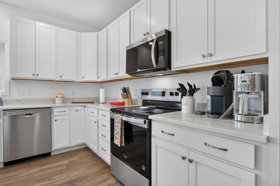 Enjoy the convenience of a fully equipped kitchen with modern appliances, ample prep space, and a Keurig and drip coffee maker for your morning brew.