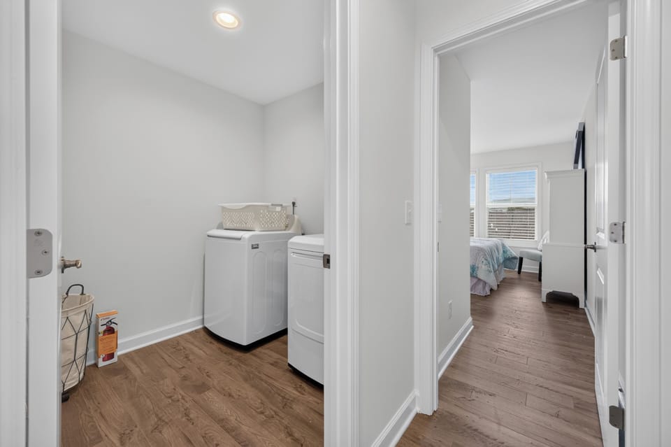 Featuring an in-unit laundry room featuring a washer and dryer located right next to the bedroom.