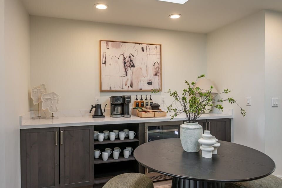 A coffee bar nook stocked with mugs, coffee, and treats for morning routines.