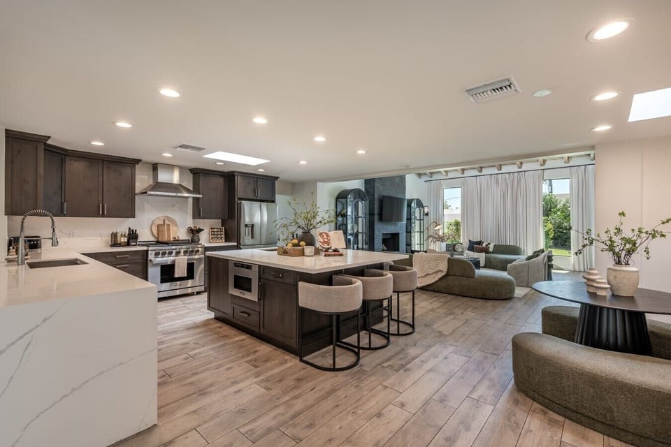 An open-concept kitchen with a large island, bar seating, and views into the living area.