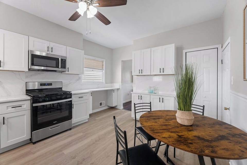 Bright modern kitchen with dining nook, stainless appliances, and ample storage